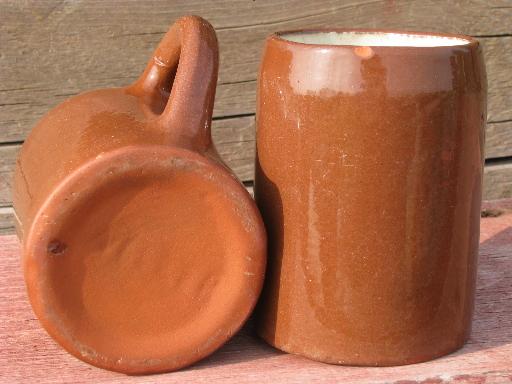 photo of worn old redware pottery beer steins or tankards, vintage cider mugs #4