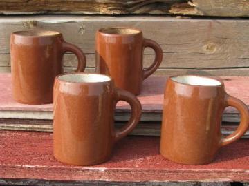 catalog photo of worn old redware pottery beer steins or tankards, vintage cider mugs