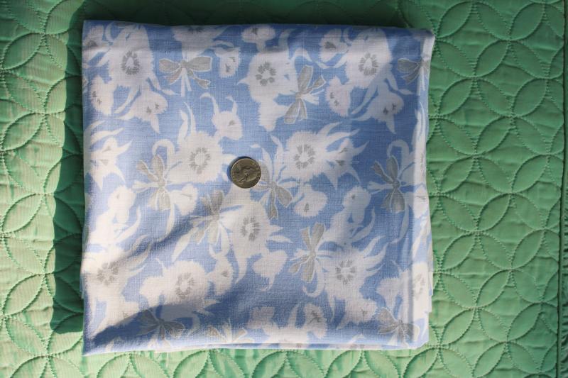 photo of worn soft vintage cotton feedsack fabric, faded print, flowers on blue #3